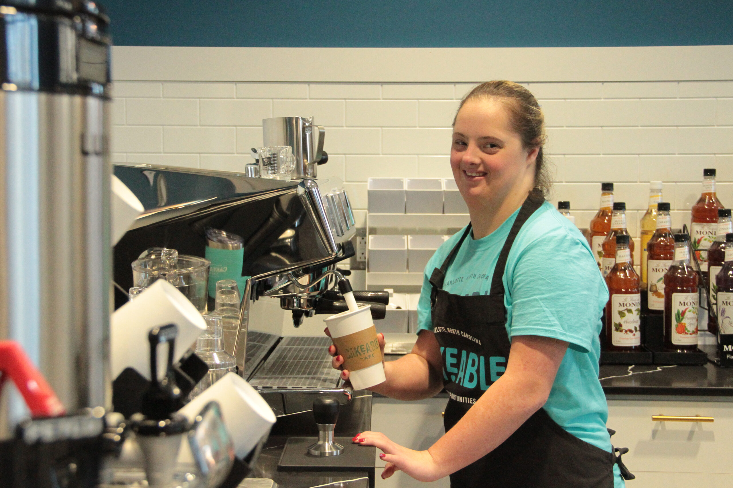 A Cakeable team member steaming milk at the espresso machine