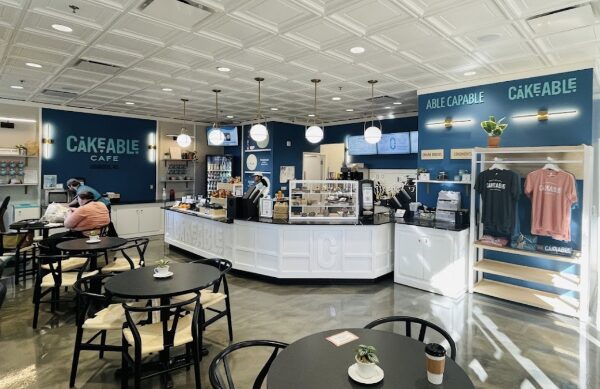 The interior of Cakeable Cafe with seating, the service counter and retail displays